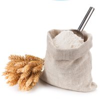 Bag of whole flour and bunch wheat on white background. Bag of whole flour and bunch of wheat on white background